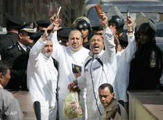 Some of 29 members of the banned Muslim Brotherhood clutch Qurans as they are led into a court in the New Cairo area of Cairo, Egypt Wednesday, Feb. 28, 2007. The court upheld Egypt's prosecution decision to freeze the assets of 29 members of the Muslim Brotherhood for financing a banned organization - causing a heavy loss for the country's most powerful opposition movement, which won 88 of parliament's 454 seats in 2005 elections with its candidates running as independents (photo: AP)
