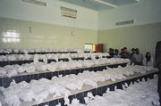 Minister Chnar Abdullah and her delegation stand before 150 white linen sacks at Al Sadr University Hospital, which specializes in the forensic investigation of mass burials (photo: Birgit Svensson)