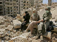 Three women in Gaza rubble (photo: AP)