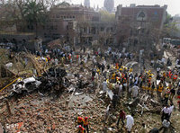 Pakistani rescue and security officials examine the site of a bomb explosion at the office of the Federal Investigation Agency in Lahore, Pakistan on 11 March 2008 (photo: AP)