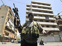 A Shiite gunman from the Amal group guards an intersection in a newly seized neighborhood in Beirut (photo: AP)