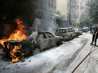 A fire fighter tries to extinguish burning cars during clashes between opposition supporters and the Lebanese army in Beirut (photo: AP)