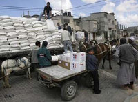 People waiting for supplies to be unloaded from a truck (Photo: AP)