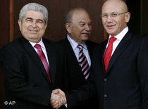 Cypriot President Dimitris Christofias, left, and Turkish Cypriot leader Mehmet Ali Talat, right, shake hands (photo: AP)