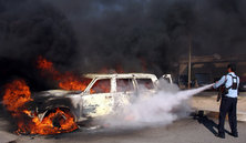 Extinguishing a fire set off by a car bomb in Iraq (photo: AP)