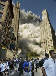 Pedestrians on Park Row flee the area of the World Trade Center as the center's south tower collapses following the terrorist attack on the New York landmark, 11 September 2001 (photo: AP)