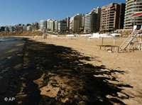 A layer of crude oil covers the beach of beirut (photo: AP)