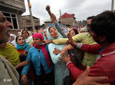 Kashmiri men try to stop women from joining the funeral procession of Fayaz Ahmed as they leave with the body from his house in Srinagar, India, Saturday, Sept. 18, 2010. Ahmed succumbed to injuries at a hospital after he was wounded in a protest last week (photo: AP)