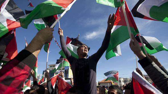 People celebrating on the streets of Ramallah after the resolution was passed by the UN (photo: AFP/Getty Images)