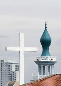 Minaret and church roof with crucifix (photo: AP)