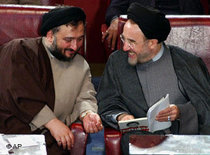 Mohammad Ali Abtahi, left, and Mohammad Khatami, talk in an open session of parliament in Tehran, April 2004 (photo: AP)