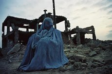 Afghanische Frau vor einer Ruine; Foto: Bucher Verlag