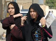 Two young women wearing a headscarf (photo: AP)