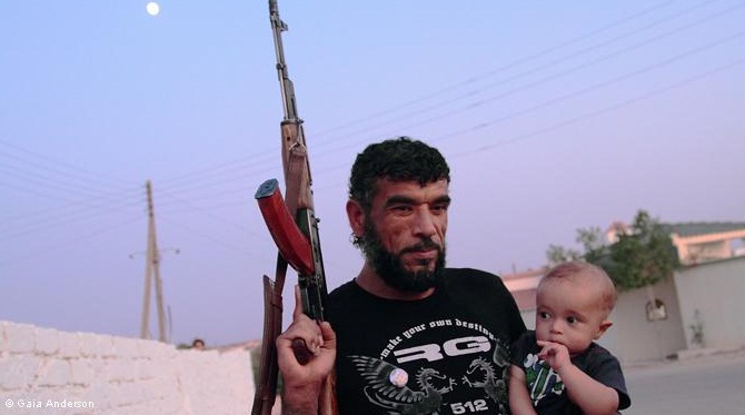 Libyan opposition fighter with child: As the conflict continues, fighters are provided with everything they need by their families