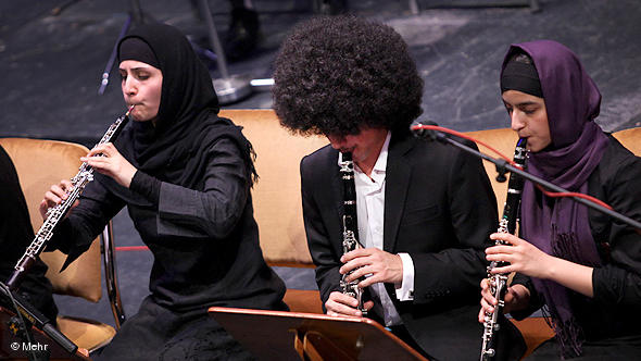 Two female musicians playing in an orchestra