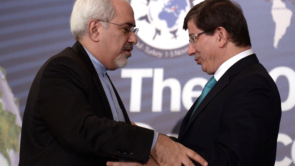 Iran's new Foreign Minister Mohammad Javad Zarif, left, and his Turkish counterpart Ahmet Davutoglu greet each other during a forum in Istanbul, Turkey, Friday, Nov. 1, 2013 (photo: AP)