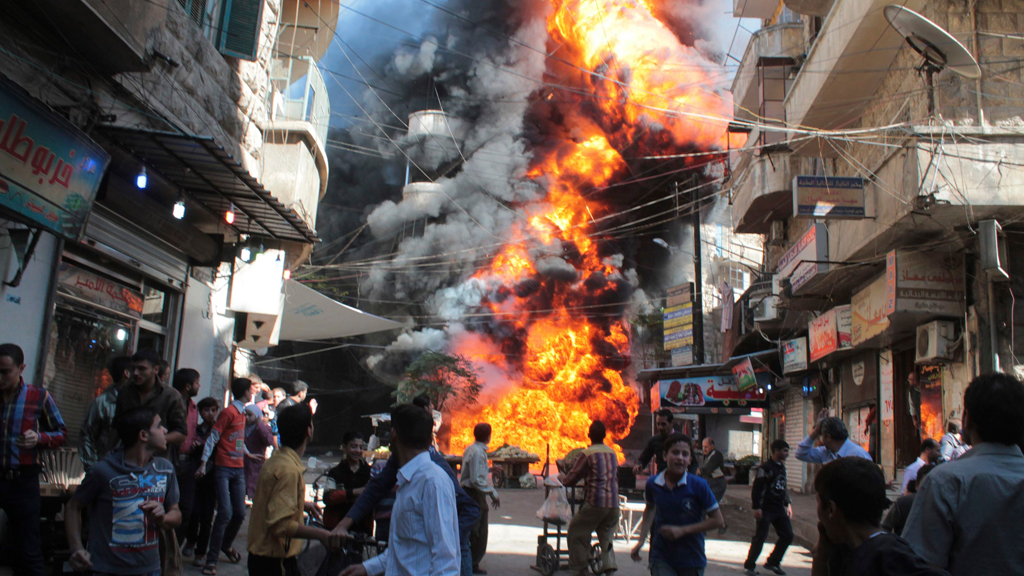 A bomb explodes in a residential area of Aleppo (photo: Reuters)