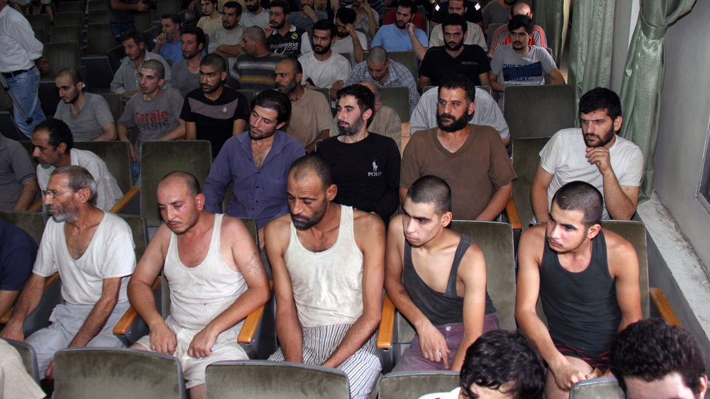 Syrian prisoners sit in a courtroom before their release in Damascus, Syria, on 1 September 2012 (photo: Bassem Tellawi/AP/dapd)