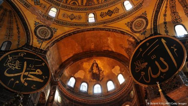 Interior of Hagia Sophia showing Islamic calligraphy and Christian fresco. Photo © Bulent Kilic/AFP/Getty Images