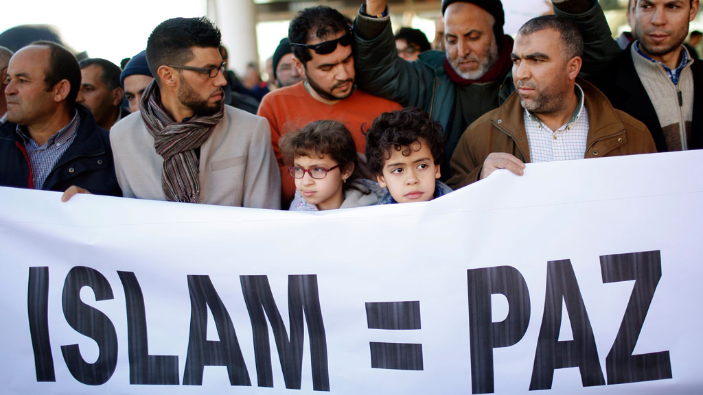 Members of the Muslim community walk behind a banner that reads, "Islam = Peace" during a rally in Madrid, 11 January 2015 (photo: REUTERS/J. Medina)