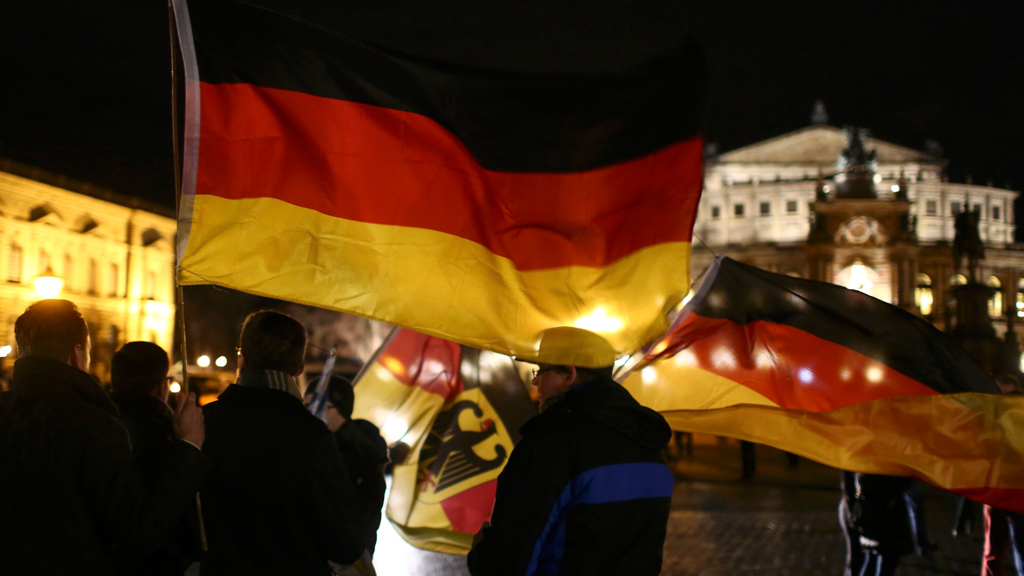 Pegida supporters waving German flags at a march in Dresden (photo: Reuters/Hannibal Hanschke)