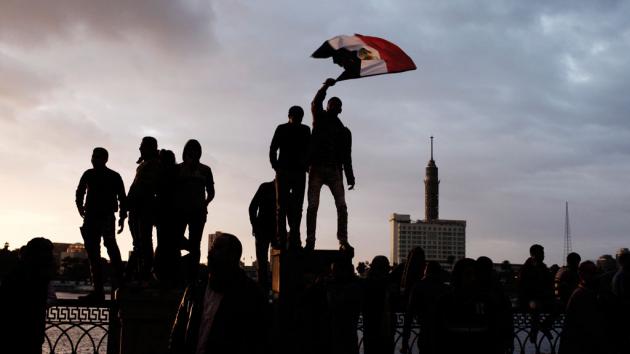 Men waving the Egyptian flag in Cairo (photo: Ed Giles/Getty Images)