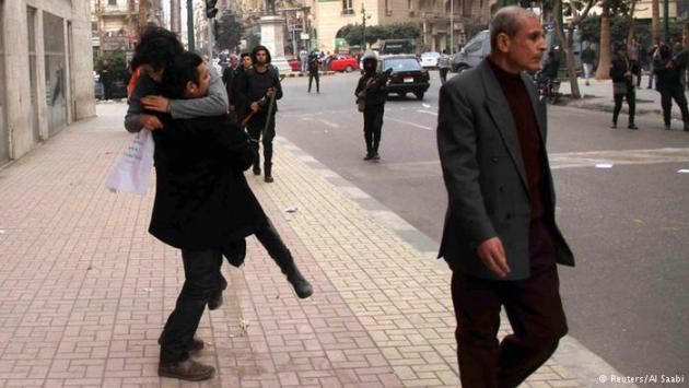 The injured Shaima Al-Sabbagh being carried away from the scene of her shooting (photo: Reuters/Al Saabi)
