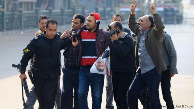 Muslim brotherhood supporters being led away (photo: Reuters/M. Abd El Ghany)