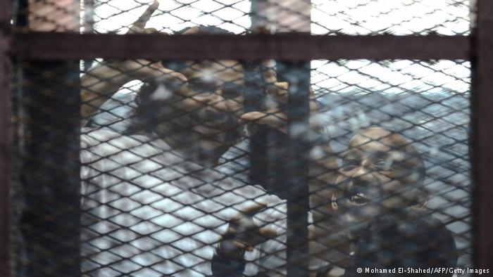 Alaa Abdel Fattah behind bars (photo: Mohamed El-Shahed/AFP/Getty Images)