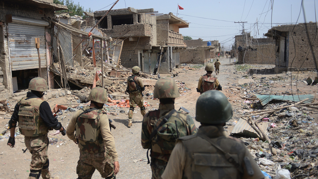 Pakistani soldiers patrol among destroyed houses during a military operation against Taliban militants, Miranshah, North Waziristan, 9 July 2014 (photo: AFP/Getty Images/A. Qureshi)