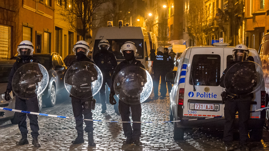 Police officers secure a street during a raid in the Molenbeek neighbourhood of Brussels, Belgium, Friday March 18, 2016. After an intense four-month manhunt across Europe and beyond, police on Friday captured Salah Abdeslam, the top fugitive in the Paris attacks in the same Brussels neighbourhood where he grew up (photo: AP/Geert Vanden Wijngaert)