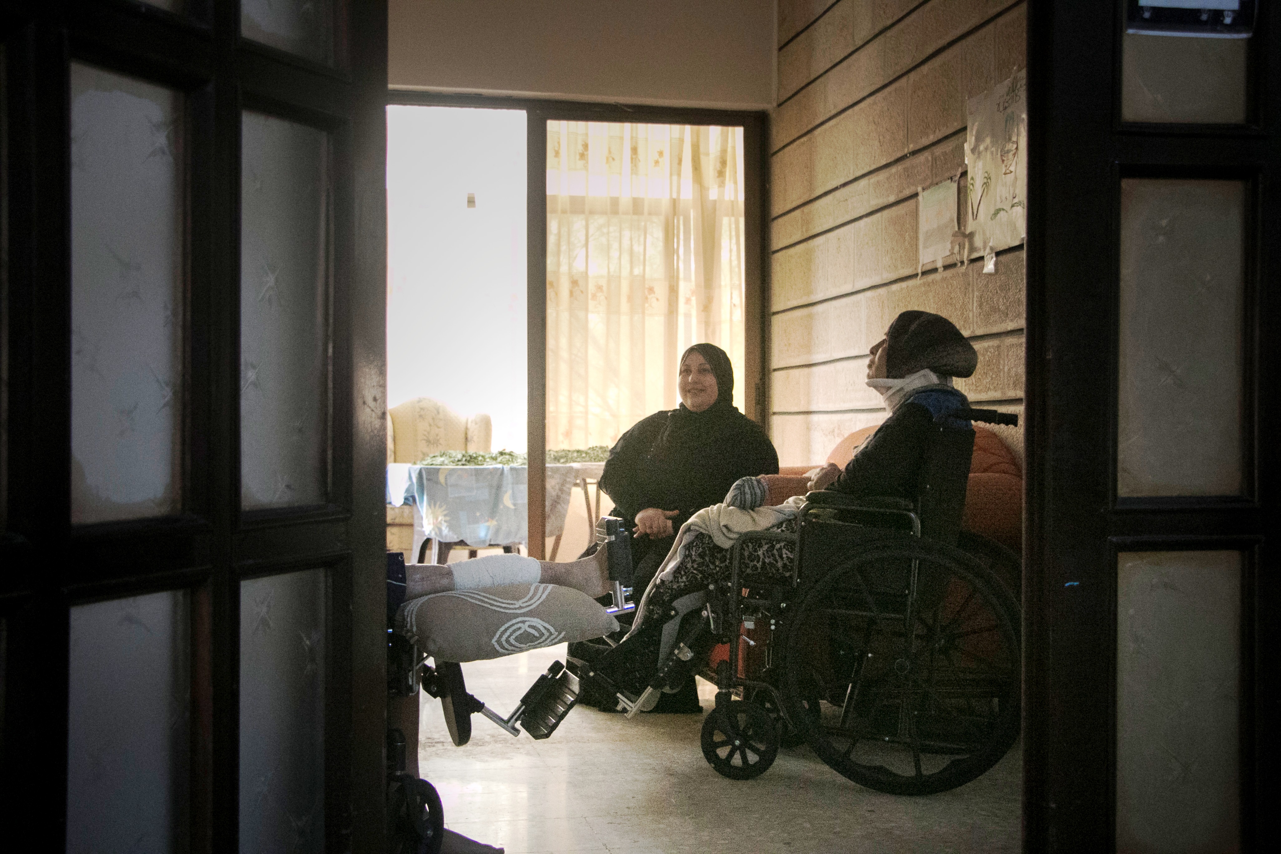 Um Salah relaxes during a break from physiotherapy with another patient and a member staff at Souriyat Across Borders (photo: Ylenia Gostoli)