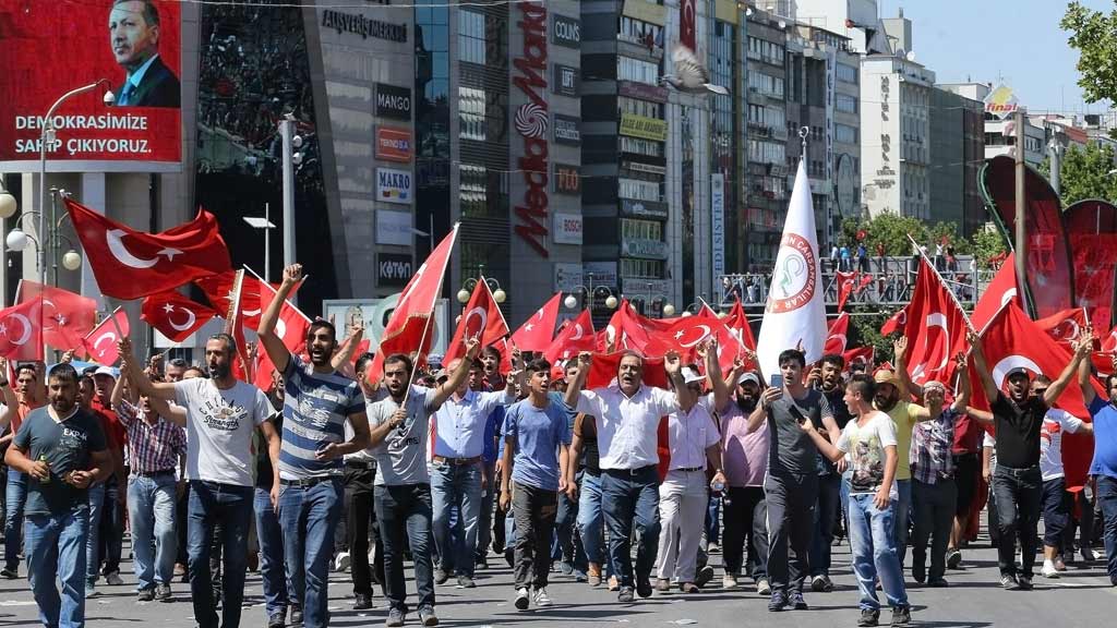 People wave national flags as they march from Kizilay square to Turkish General Staff building to react against the attempted military coup, in Ankara, on 16 July 2016 (photo: Getty Images/AFP/A. Altan)