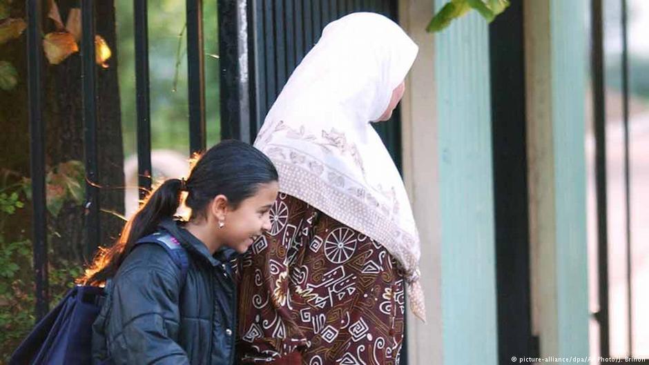 A French Muslim brings her daughter to school in the Paris suburb of  Aubervillers