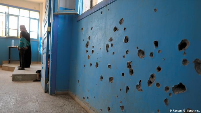 Bullet holes in a wall of a school in Syria (photo: Reuters/Z. Bensemra)