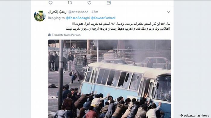 Protesters push over a bus (source: twitter_arteshbood)