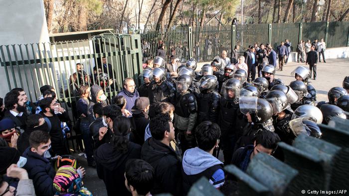 Students face police at Tehran University, 30 December 2017 (photo: Getty Images/AFP)
