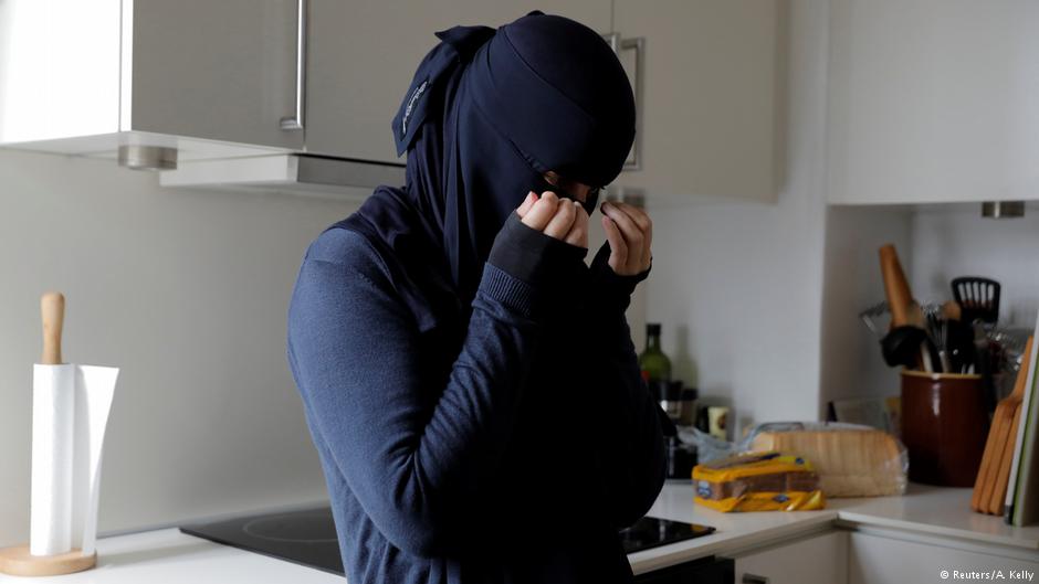 Ayah, 37, a wearer of the niqab, wipes tears from her eyes on the first day of the implementation of the Danish face veil ban on 1 August 2018 (photo: Reuters/Andrew Kelly)