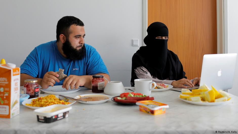 Meryem, 20, a wearer of the niqab and a member of the group Kvinder I Dialog (Women In Dialogue), sits with her husband Ali, 23, as she updates her blog Niqabi Nuancer over a vegan breakfast in Aarhus, Denmark, July 28, 2018 (photo: Reuters/Andrew Kelly)