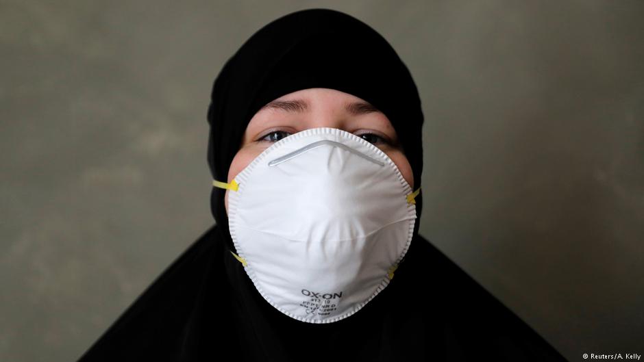 Aicha, 29, from Jutland poses with the mask she wore to the protest (photo: Reuters/Andrew Kelly)