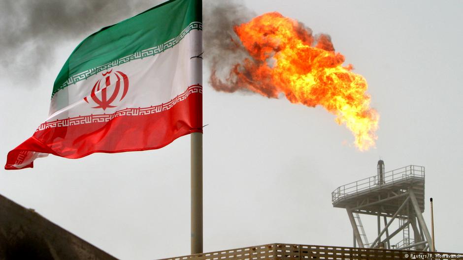 A gas flare on an oil production platform in the Soroush oil fields is seen alongside an Iranian flag (photo: Reuters/R. Homavandi)