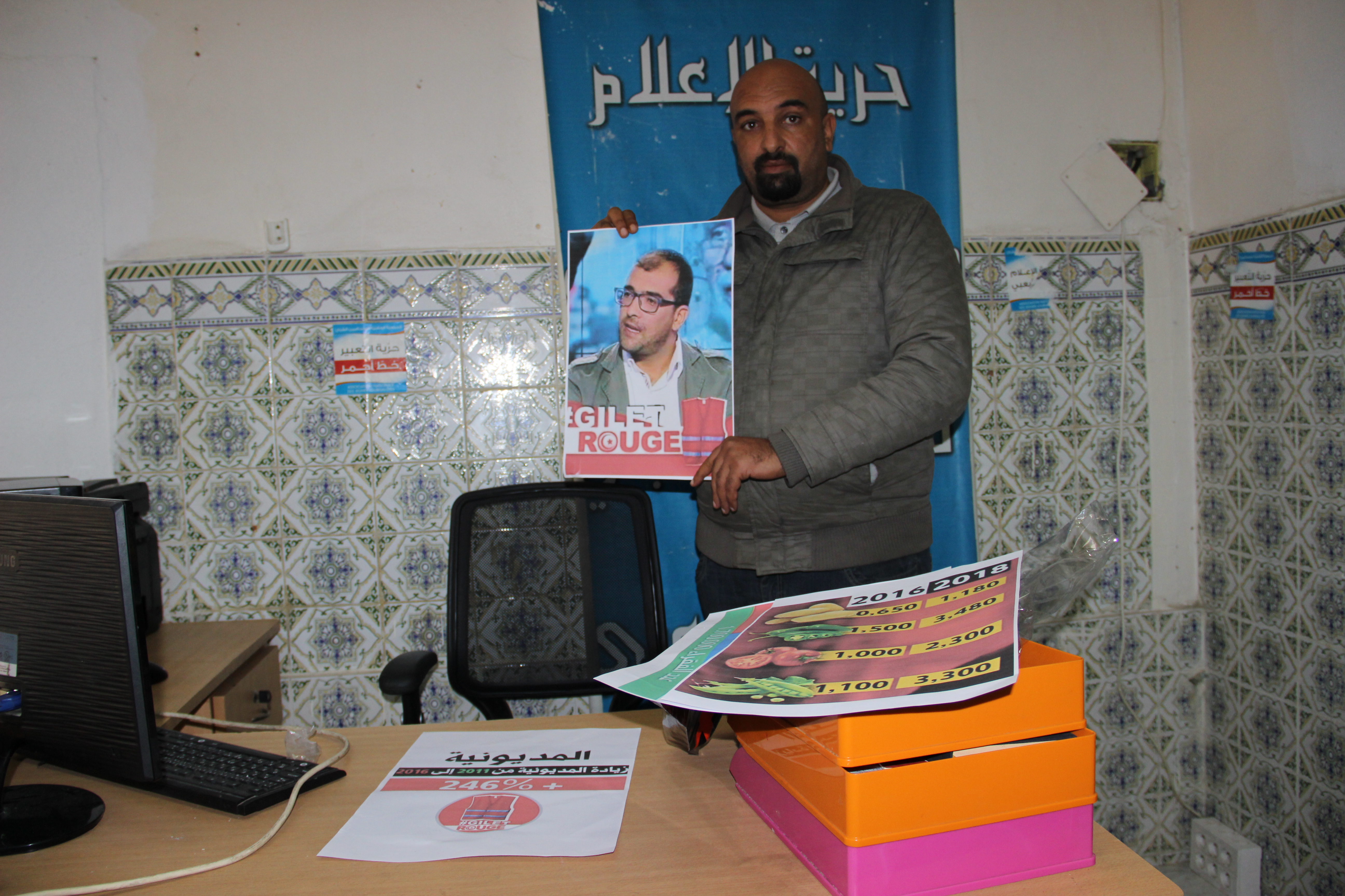 Yassin Ouerghi holding photo of co-founder Bourhan al-Ajlani, currently in detention (photo: Alessandra Bajec)