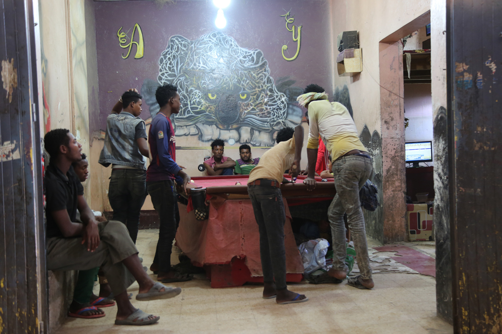 African migrants playing pool in a games and Internet cafe (photo: Ahmed Nagis)
