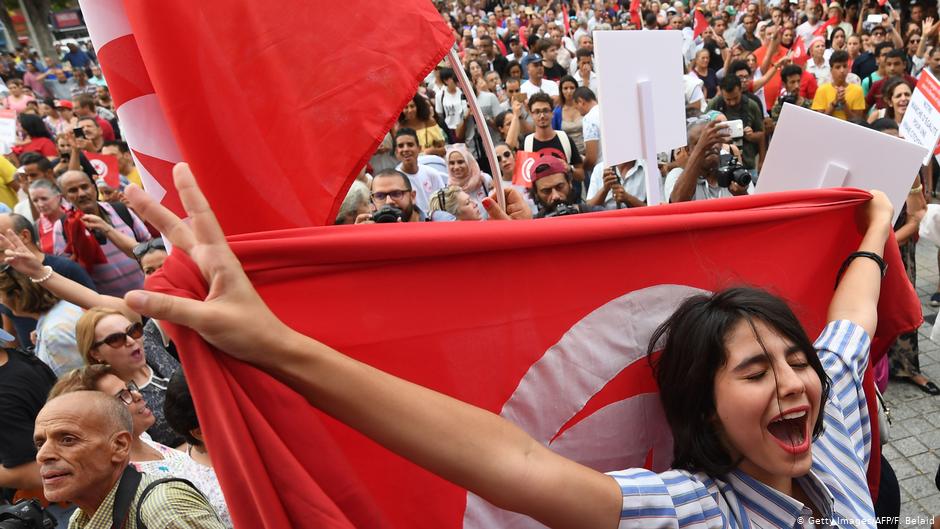 Tunisian women chant slogans as they wave national flags during a demonstration to mark Tunisia's Women's Day and to demand equal inheritance rights between men and women in Tunis on 13 August 2018 (photo: AFP/Getty Images/Fethi Belaid)