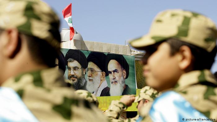 Sheikh Hassan Nasrallah appears on a banner with Iranian Ayatollahs Khamenei and Khomeini (photo: picture-alliance/dpa)