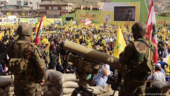 Hezbollah fighters brandish their weapons during celebrations to mark the fifteenth anniversary of Israel's retreat from South Lebanon (photo: picture-alliance/AA)
