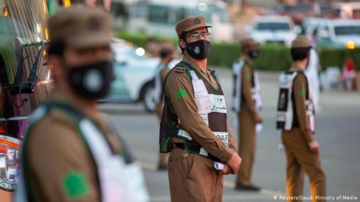 Saudi security officers wearing protective masks (photo: Reuters/Saudi Ministry of Media)