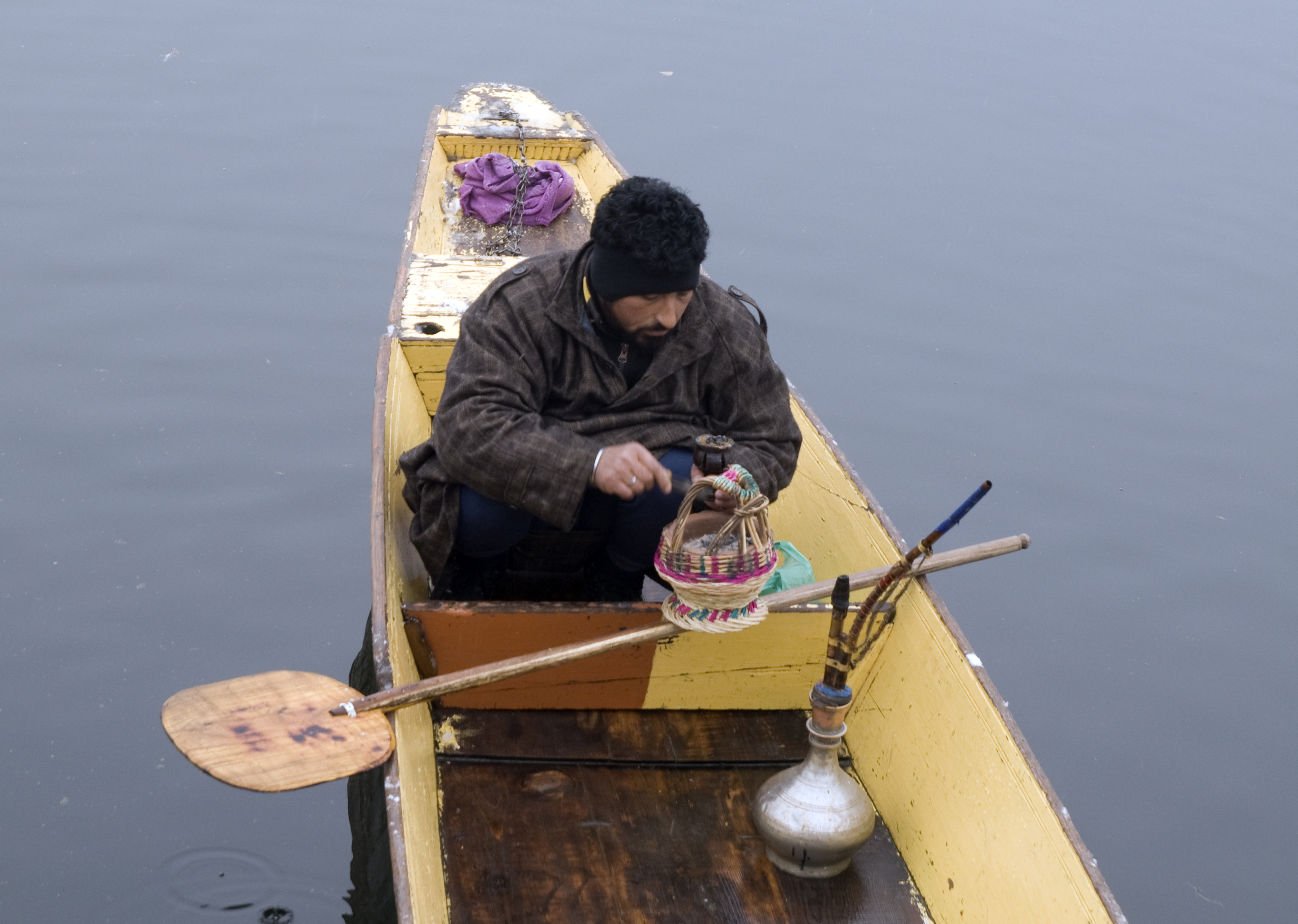 A boatman warms his hands on Lake Dal, Kashmir (photo: Sugato Mukherjee)