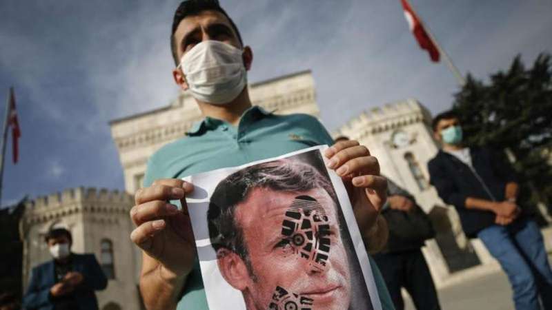 في إسطنبول ملصقات تُظهِر الرئيس الفرنسي إيمانويل ماكرون وعلى وجهه طبعة حذاء - تركيا.  Foto: AP/dpa