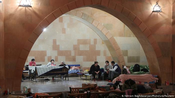 People sitting on benches, cots and chairs in a shelter in Stepanakert (photo: Vahram Baghdasaryan/Photolure/Reuters)